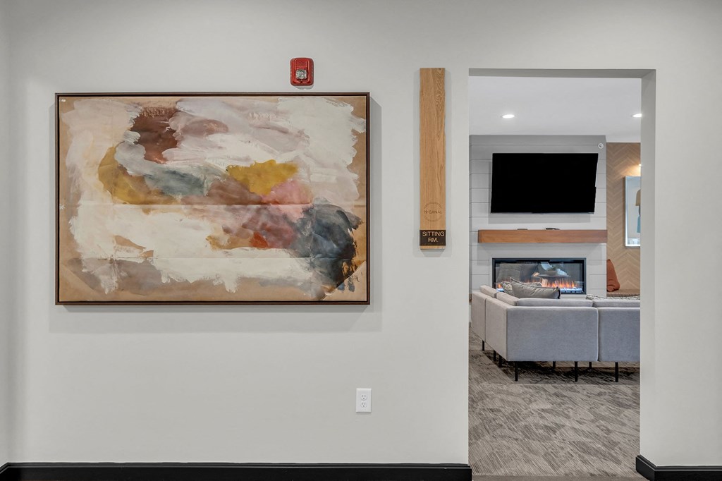 a painting hanging on a wall in a living room