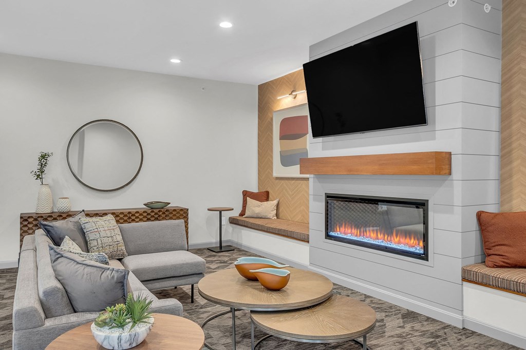 a living room with a fireplace and a television