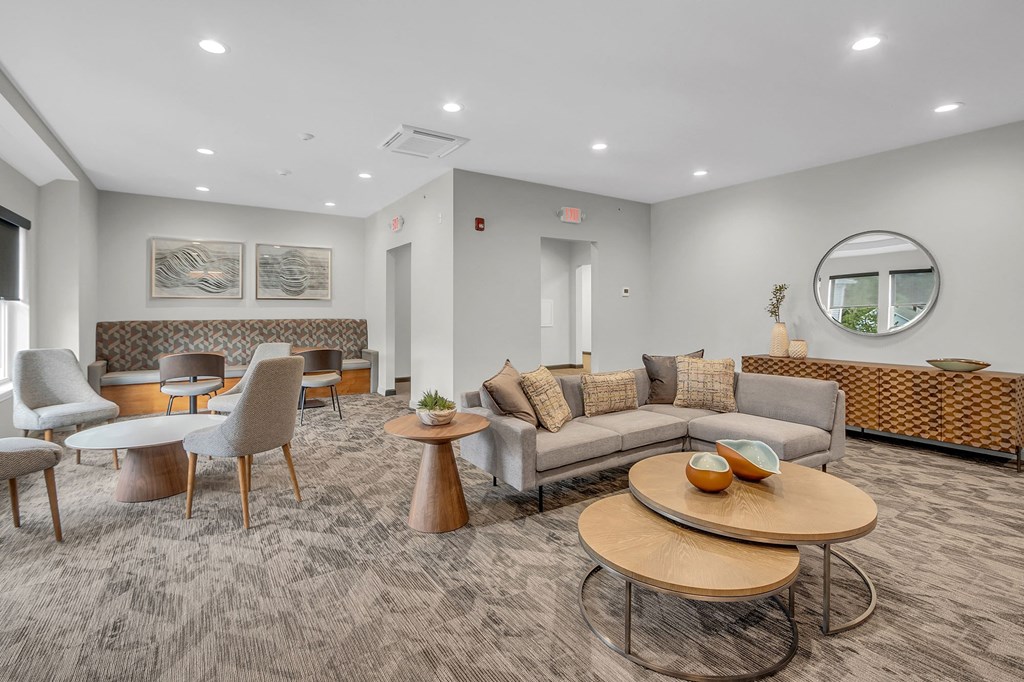 a living room with couches and chairs and tables