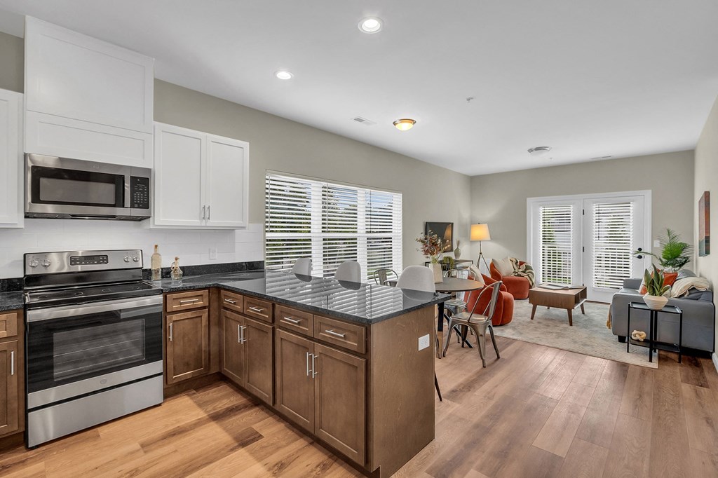 a kitchen with an island and a living room with a table