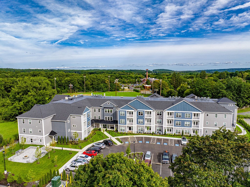an aerial view of a large building surrounded by trees
