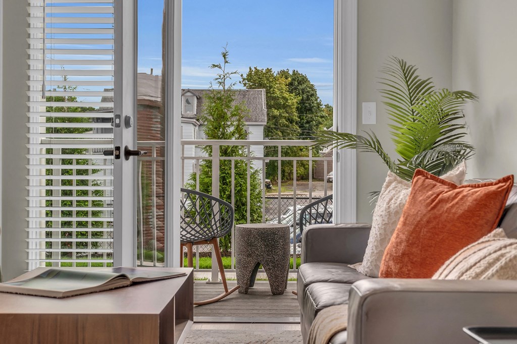 a living room with a couch and a balcony