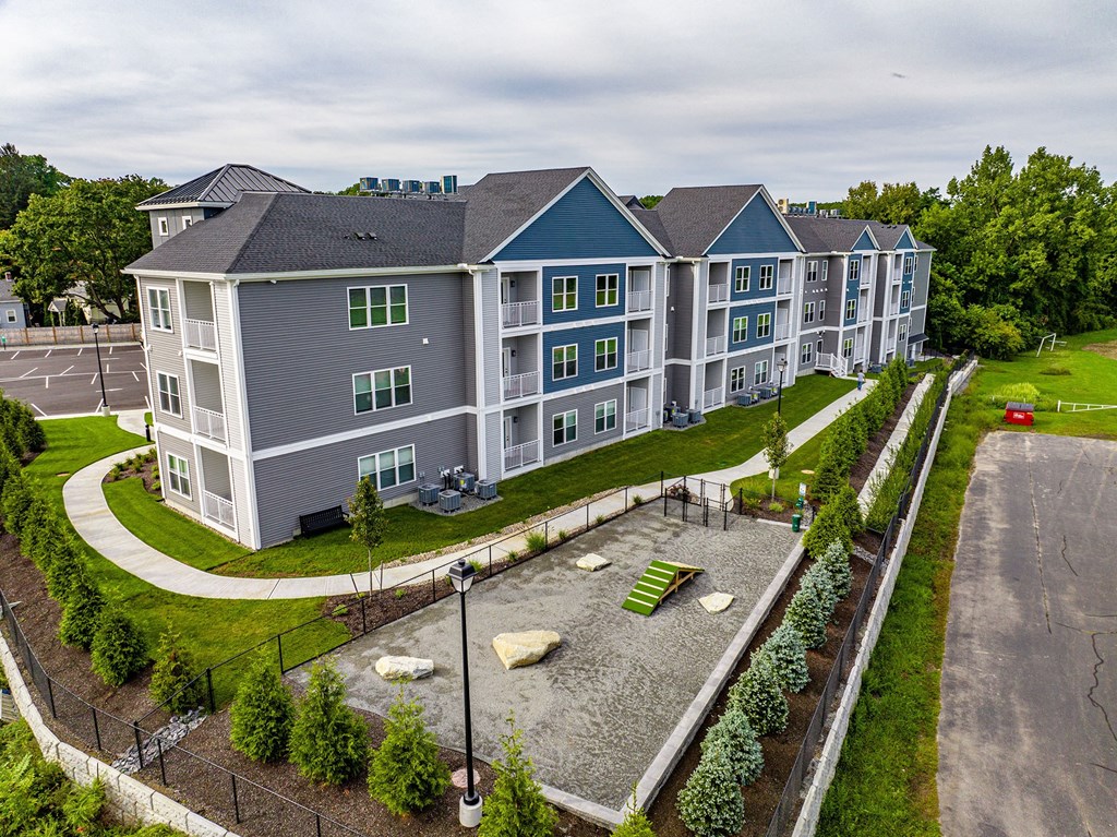 an aerial view of a large apartment building with a parking lot