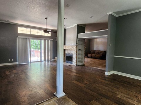 a living room with a fireplace and a hard wood floor