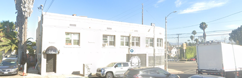 a white building with cars parked in front of it