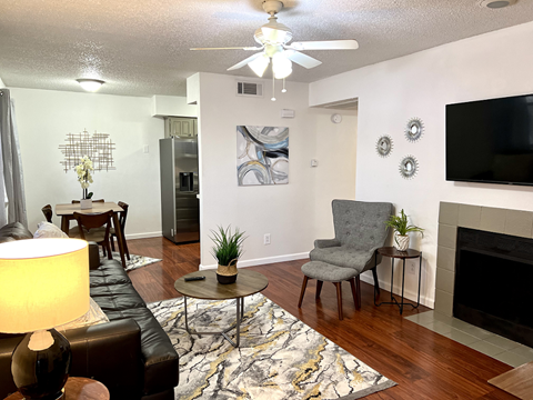 the view of a living room with a tv and a table