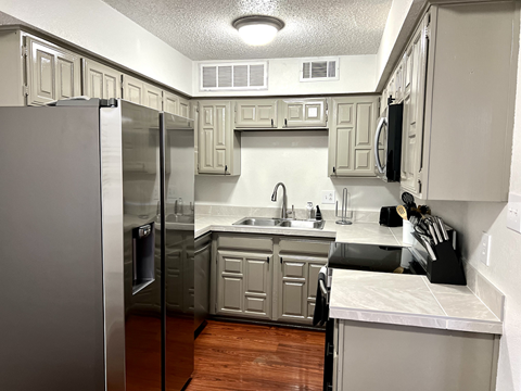 a kitchen with stainless steel appliances and white cabinets