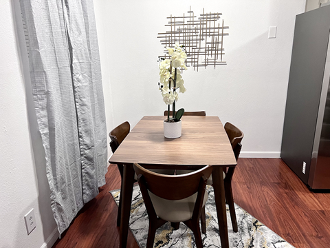 a dining room with a wooden table and chairs