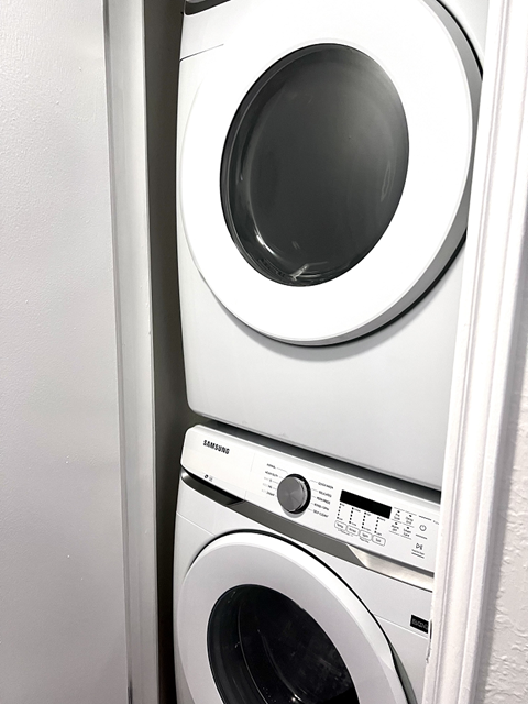 a washing machine and a dryer in a laundry room