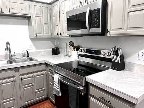 a kitchen with stainless steel appliances and white cabinets