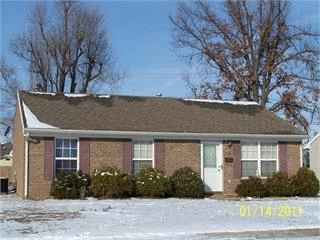 a brick house with snow on the ground