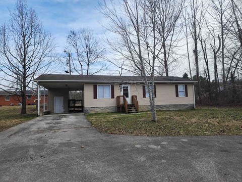A house with a grey roof and a grey driveway.