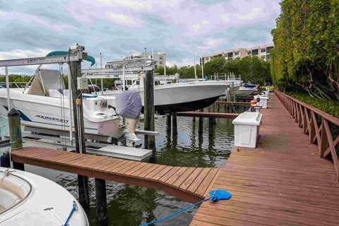 A boat is docked at a wooden pier.