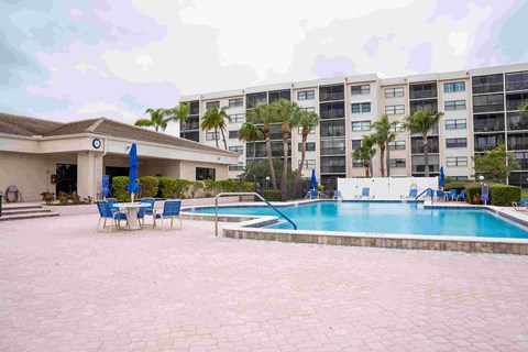 A pool area with a building in the background.