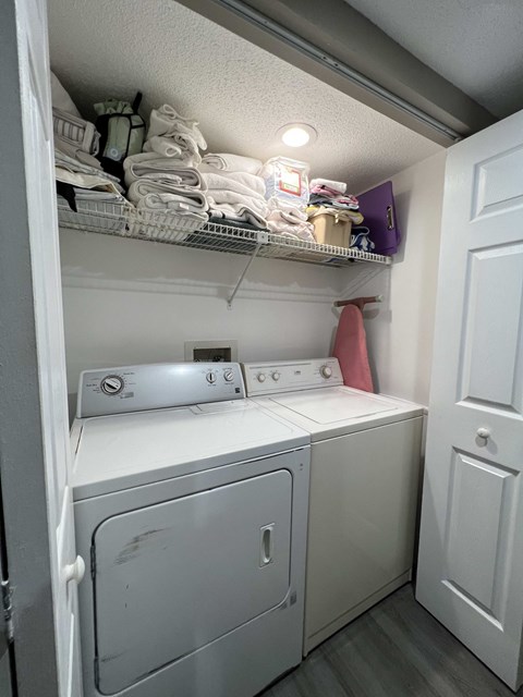 A small laundry room with a washer and dryer.