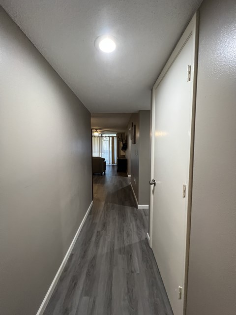 A long hallway with a light on the ceiling.