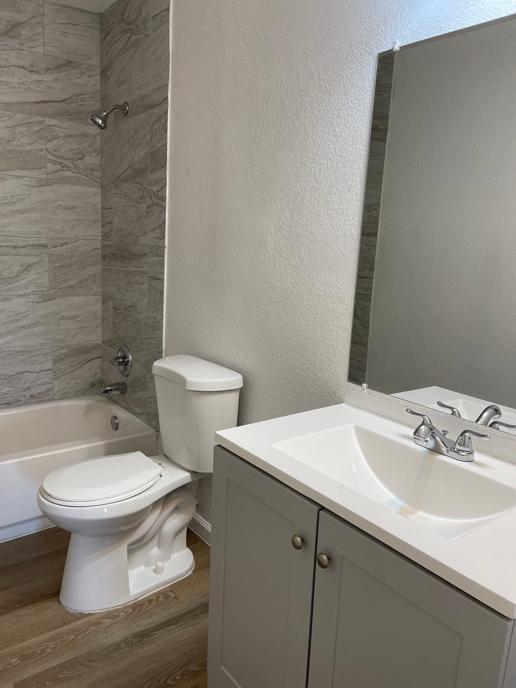 a bathroom with a toilet and a sink and a bath tub