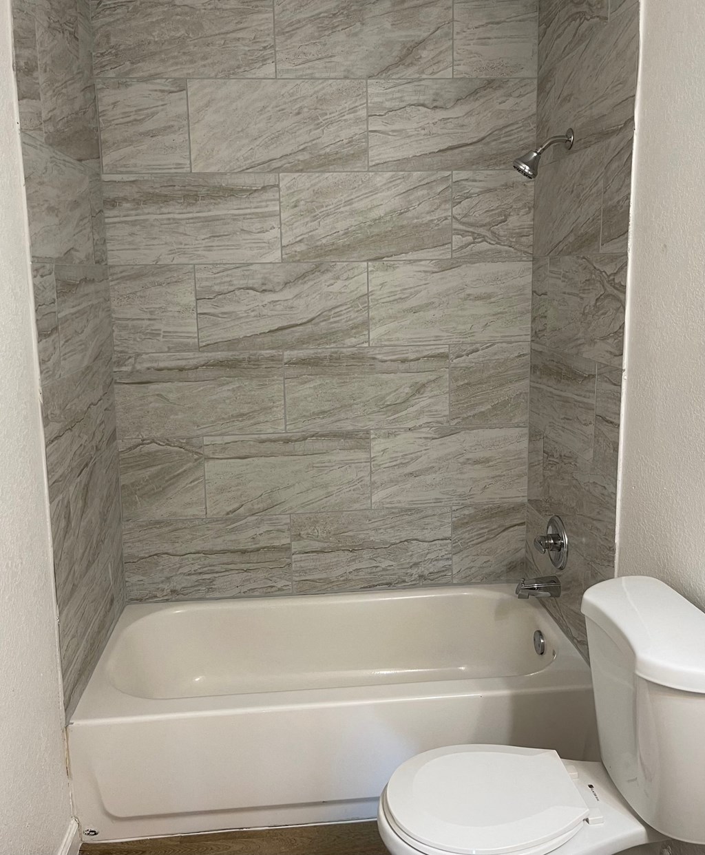 a bathroom with a toilet and a bath tub