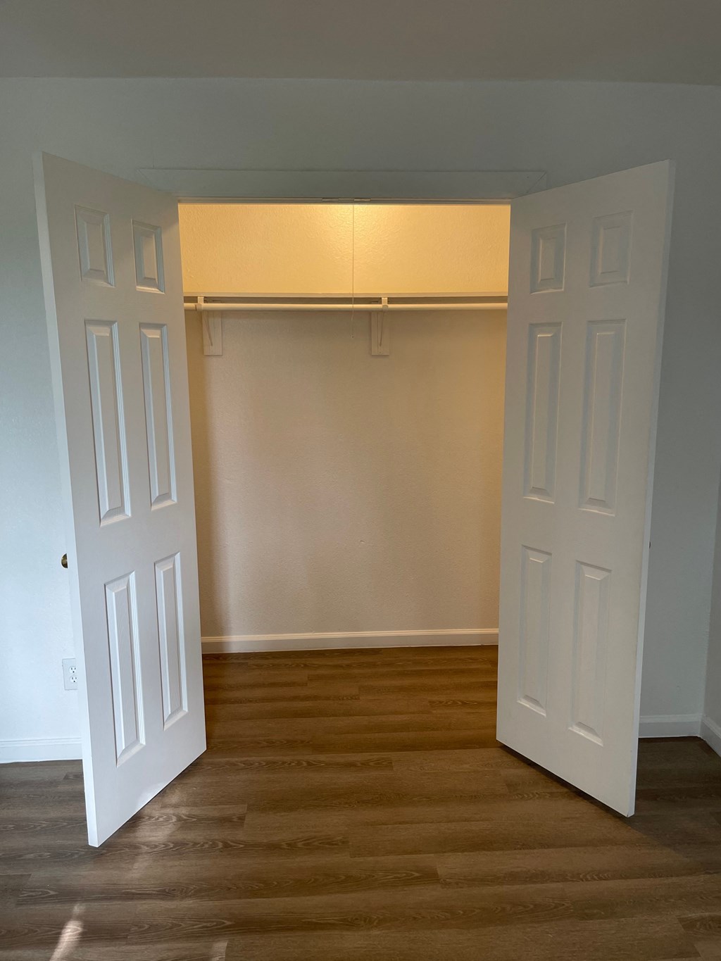 an empty room with a closet and a door