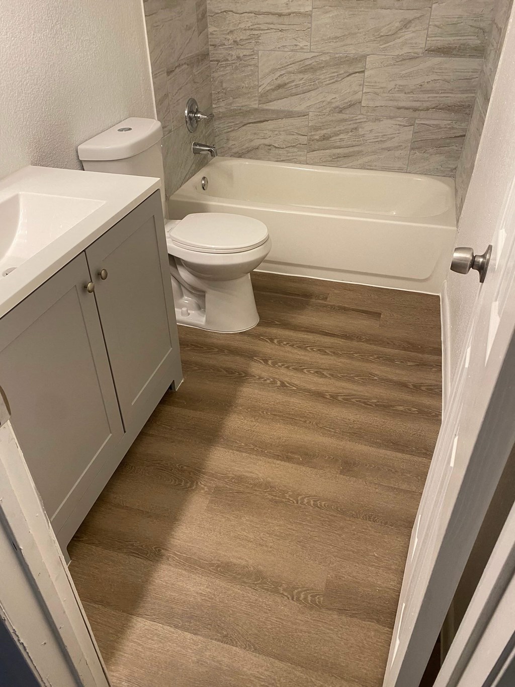 a bathroom with a toilet and a sink and a bath tub