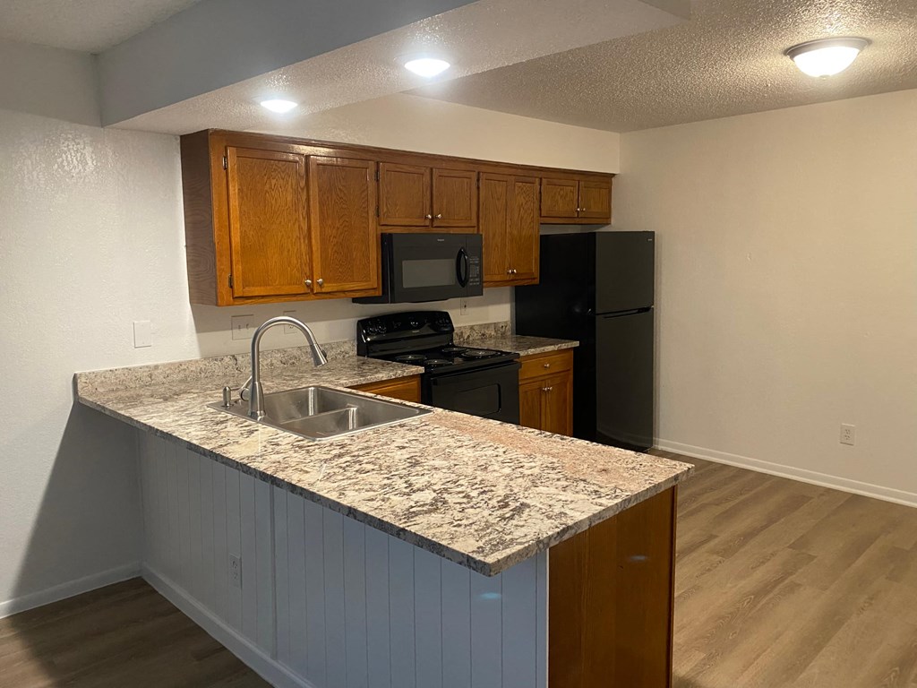a kitchen with a granite counter top and a sink