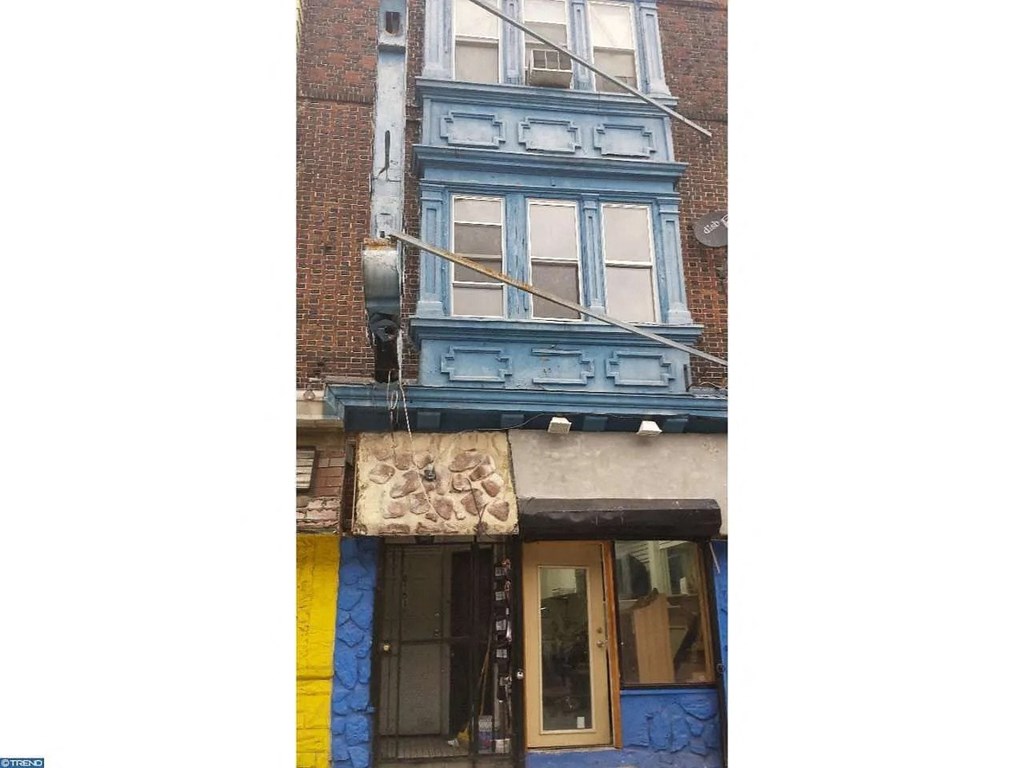 a blue building with a sign on the front of it