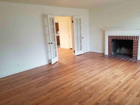 a living room with wood flooring and a fireplace