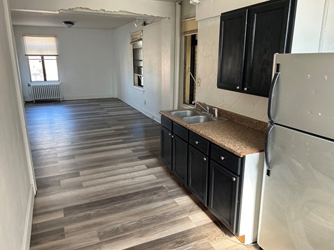 a kitchen with a sink and a refrigerator