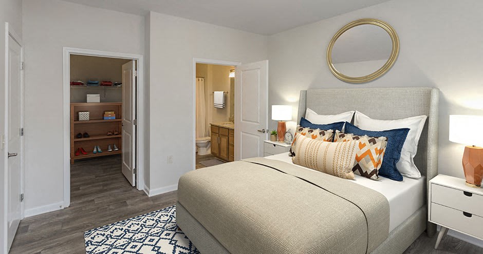 a bedroom with a bed and a door to a bathroom