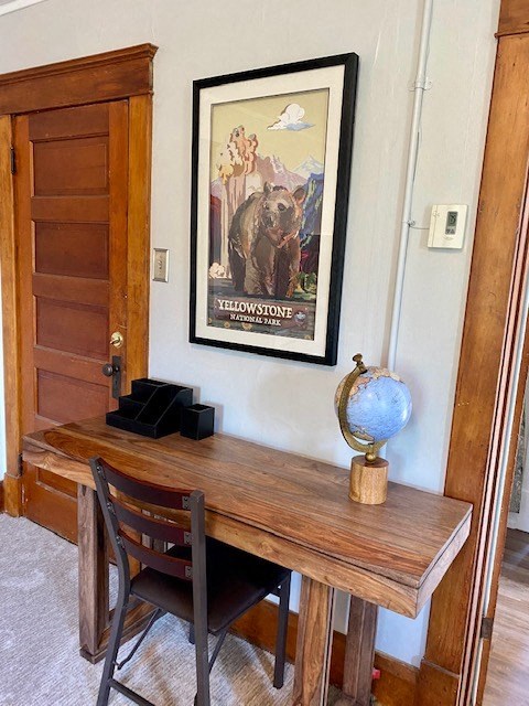 a desk with a chair and a globe on top of it