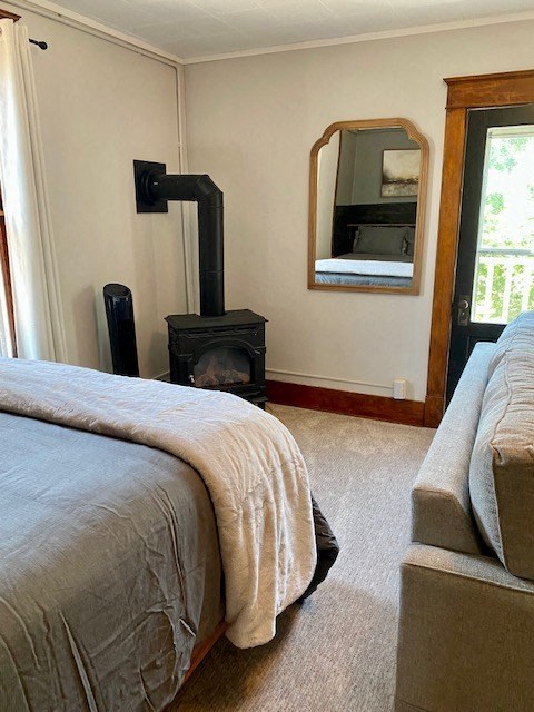 a bedroom with a bed and a wood stove