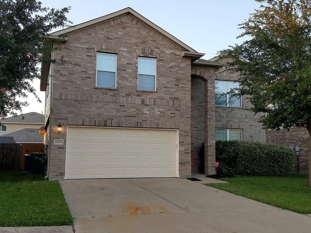 a brick house with a white garage door