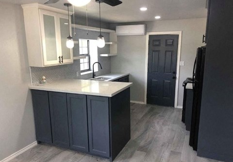 a kitchen with blue cabinets and a white counter top