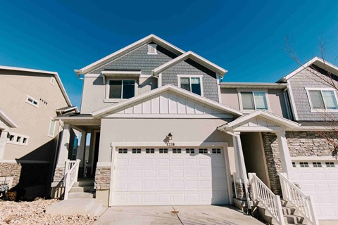 a house with a white garage door in front of it