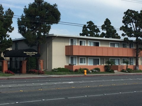 the front of a building with a yellow fire hydrant