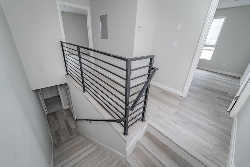 the view from the top of a staircase in a new home with wood flooring