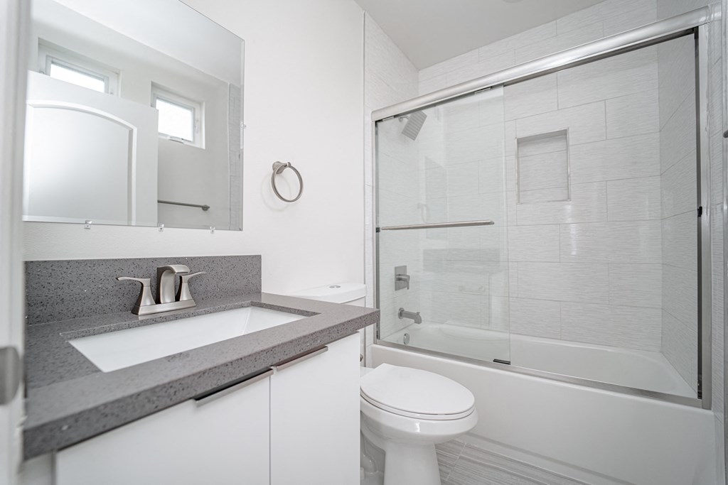 a bathroom with a sink toilet and a shower