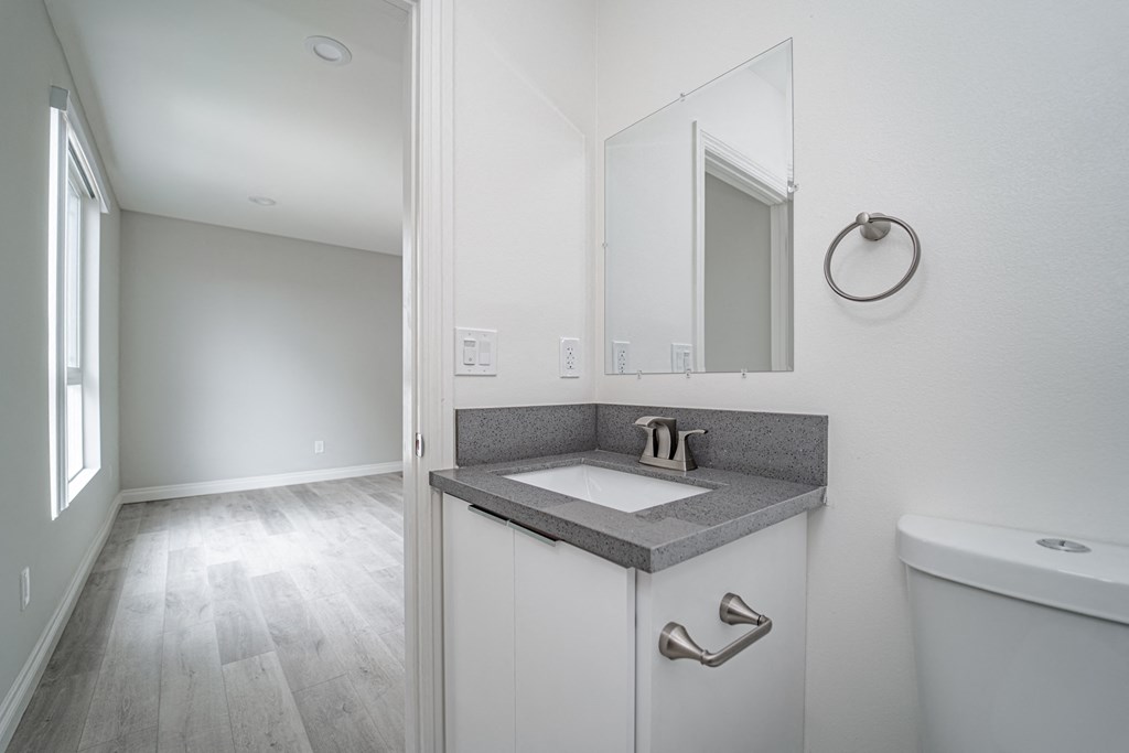 a bathroom with a sink and a mirror in a house