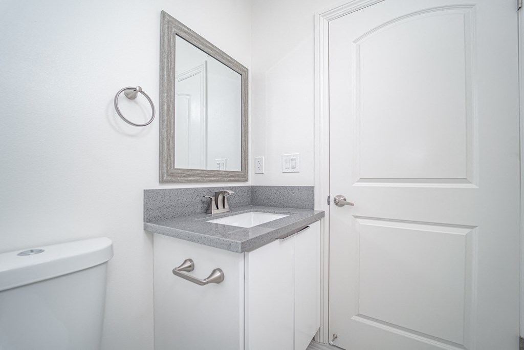 a small bathroom with a sink and a mirror