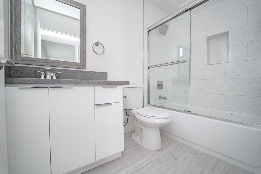 a bathroom with a toilet and a sink and a shower