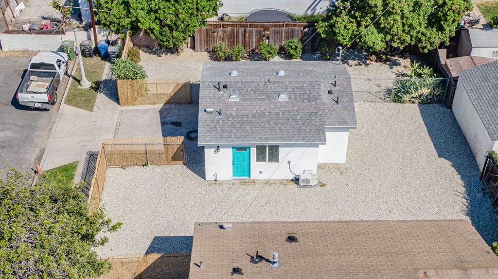 a birds eye view of a white house with a gray roof