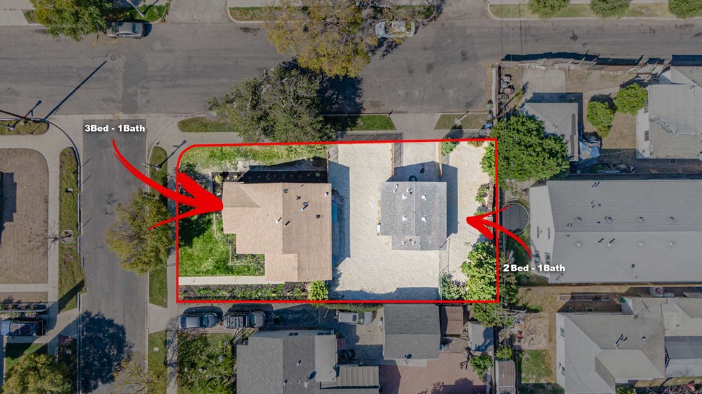 an aerial view of a neighborhood with a lot of houses and roofs with red arrows