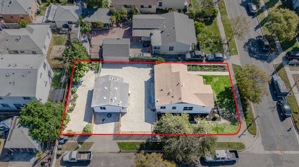 an aerial view of a neighborhood with a house with a red line around it