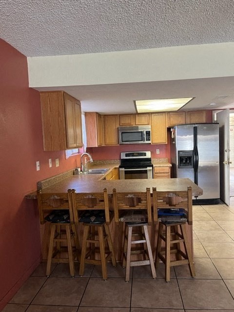 A kitchen with a table and chairs.