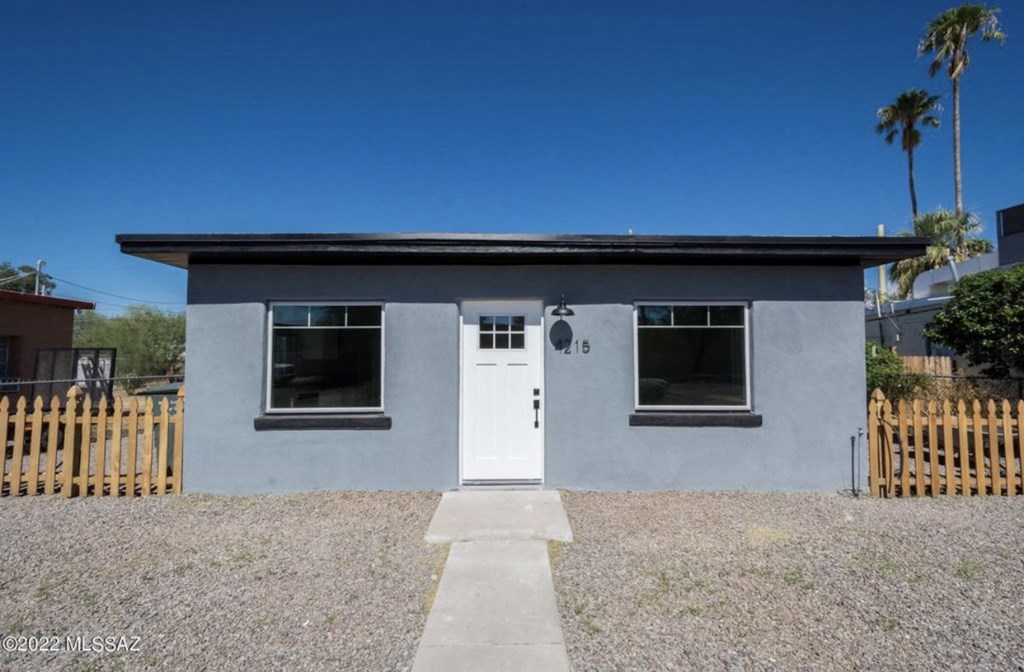 the front of a small house with a white door
