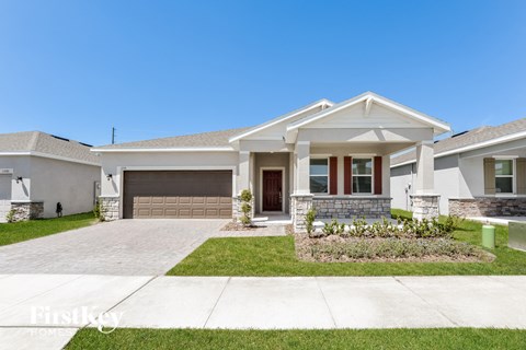 a white house with a driveway and a garage door