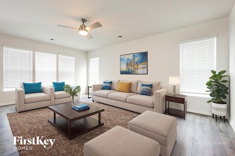 A living room with a couch, a coffee table, and a painting on the wall.