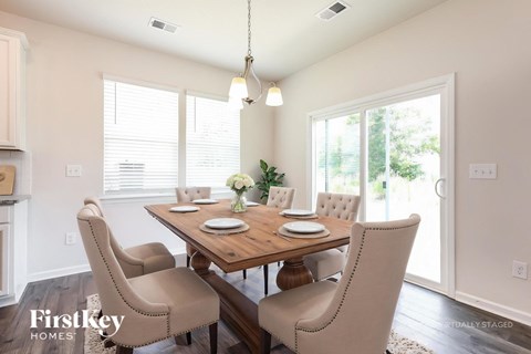 A dining room with a wooden table and chairs.