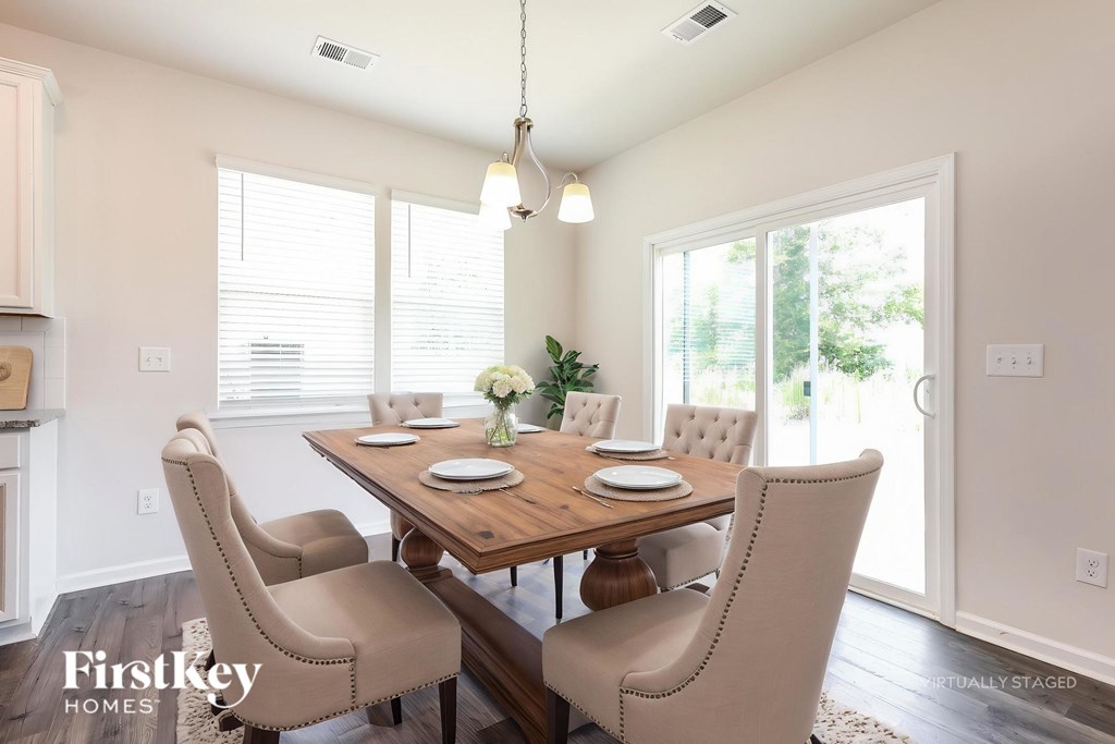 A dining room with a wooden table and chairs.