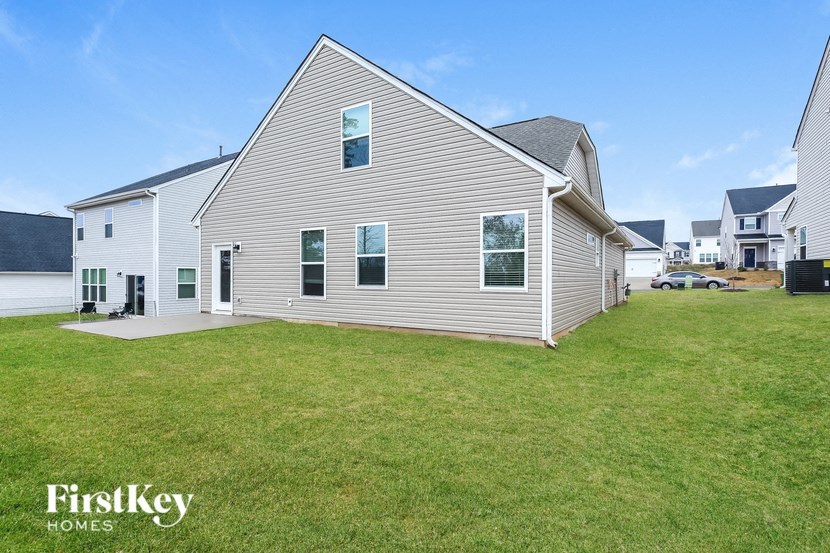 a white house with a yard in front of it